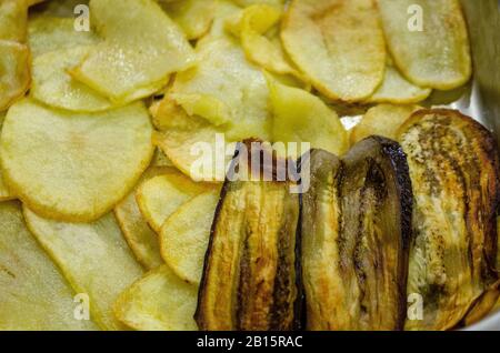 Eggplants baked on paper in a baking tray Stock Photo