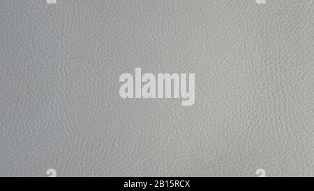 Light grey artificial or synthetic leather background with neat texture and copy space, colorful fabric sample with leather-like finish Stock Photo
