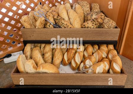 on a breakfast buffet there are two baskets filled with different kinds of bread rolls Stock Photo