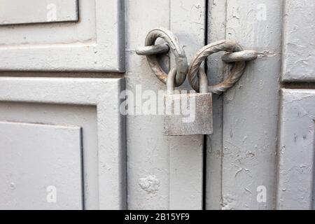 Old grey vintage lock on an iron door. Background Stock Photo