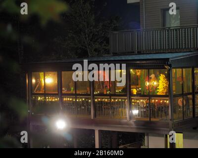 Sochi, Russia - 13 October 2019. Night view from the street to the cafe located on the veranda Stock Photo