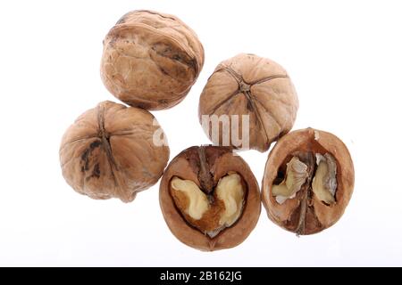 Whole and cracked walnuts isolated on white background Stock Photo