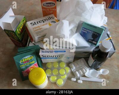 Variety of over-the-counter medicines to keep in the kitchen cupboard to help with the symptoms of the common cold. Stock Photo
