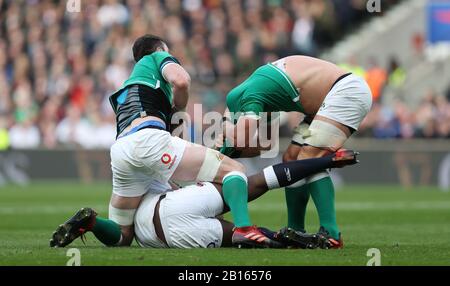 England's Maro Itoje (floor) scuffles with Ireland's James Ryan and CJ Stander during the Guinness Six Nations match at Twickenham Stadium, London. Stock Photo