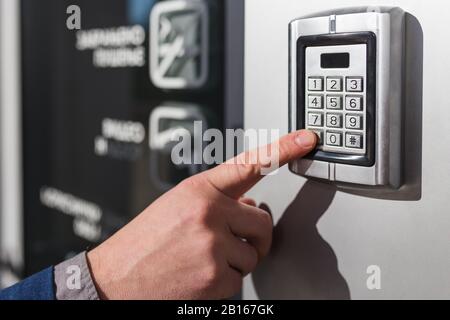 Man hand pressing the security code combination to unlock the door Stock Photo