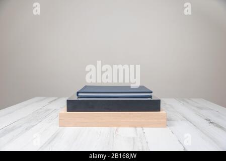 Stack of 3 albums books on isolated white blurred background with blank empty room space for text or copy. Stock Photo