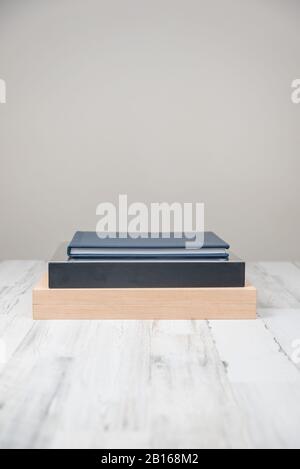 Stack of 3 albums books on isolated white blurred background with blank empty room space for text or copy. Stock Photo