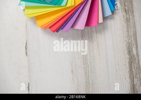 Colorful stack of sample test swatches for paint or fabric in spectrum rainbow colors with blank empty room space for text or copy. Stock Photo