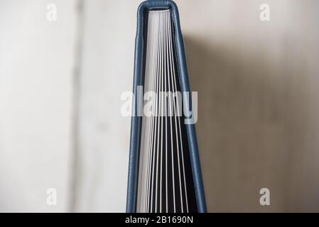 Top view close up of thick and rigid wedding album pages in a navy blue leather book with binding and spine. Blank empty room space for text or copy. Stock Photo