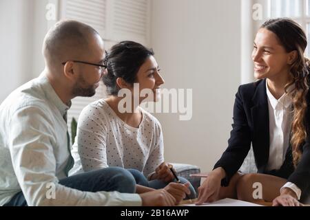 Multi-ethnic family clients feels satisfied sign contract during meeting Stock Photo