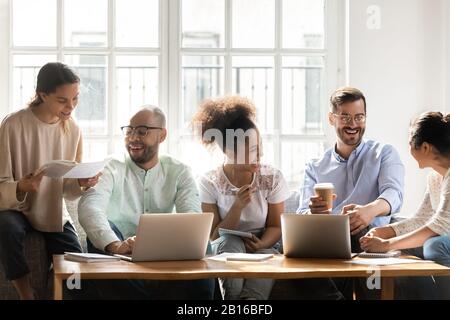 Multinational students studying together working on common research project indoors Stock Photo