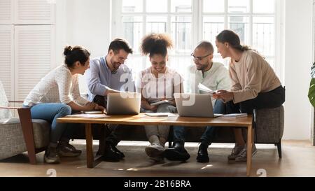 Diverse students studying together working on common research project Stock Photo