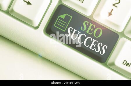 Writing note showing Seo Success. Business concept for accomplishment or achievement of increasing traffic to a website Stock Photo