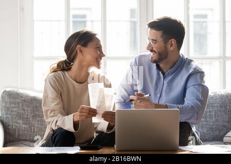 Couple sitting on sofa busy with manage household budget Stock Photo