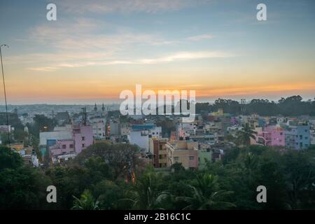 View of Sunrise Over Bangalore Neighborhood With Dense Vegetation in the Foreground Stock Photo