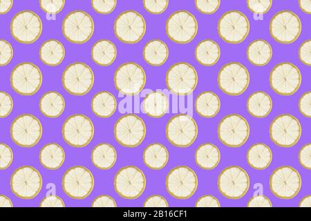 Colorful fruit pattern of fresh lemon slices on purple background. From top view Stock Photo