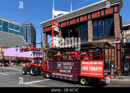 Nashville, TN, USA - September 21, 2019:  Revelers enjoy drinks on a Nashville party tractor off Broadway Street, something that is popular with touri Stock Photo