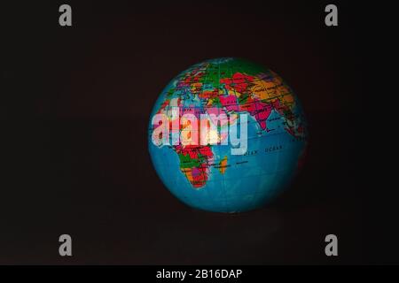 Multicolored globe isolated on a dark background. Stock Photo