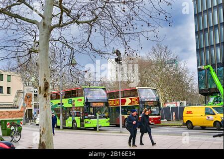 Berlin, Germany - February 21, 2020: Street scene with two hop-on-hop-of busses for tourists in downtown Berlin, Germany. Stock Photo