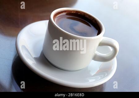 Close-up of Turkish coffee in white ceramic cup Stock Photo