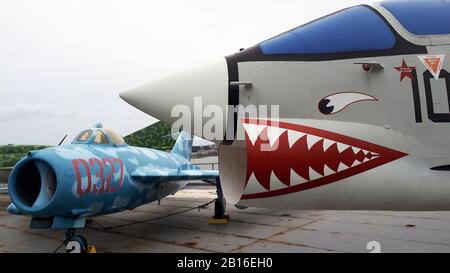 Vought F8 fighter jet with teeth decals and Mig 17 on flight deck of the USS Intrepid aircraft carrier museum ship docked on River Hudson Stock Photo