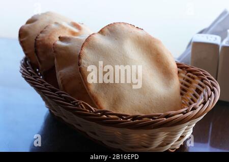 Loaves of freshly baked Arabic flat pita bread in basket Stock Photo