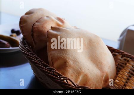 Loaves of freshly baked Arabic flat pita bread in basket Stock Photo