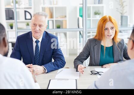 Portrait of two business people interviewing candidates for job position in modern office Stock Photo