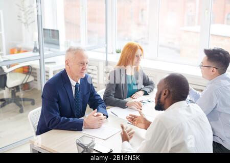 High angle view at HR managers interviewing two candidates for job position in office, copy space Stock Photo