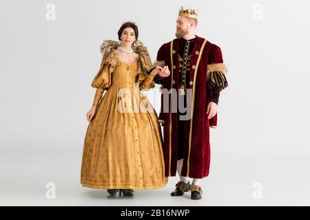 queen and king with crowns holding hands isolated on grey Stock Photo -  Alamy