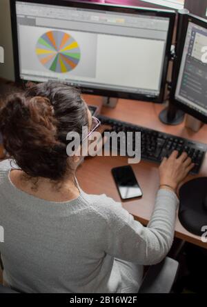 Top view of a woman working at home using computer and mobile. Teleworking, the new way of working. Stock Photo