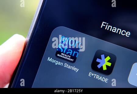 Morgan Stanley and E*TRADE apps seen on the smartphone screen hold in a hand. Stock Photo
