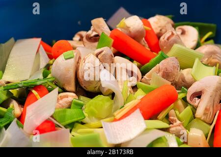 A mixture of fresh leeks, carrots, and mushrooms Stock Photo