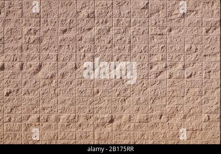New wall surface. A pattern simulating the surface of tiles has been applied to the plaster. Stock Photo