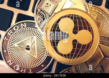 Ripple, Tron and Neo Golden Cryptocurrency Coins Closeup Photo. Pile of Coins. Business Theme. Cryptocurrency Investing Concept. Stock Photo