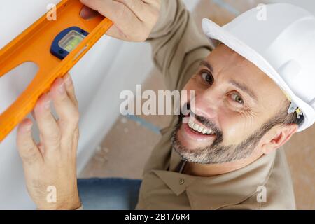worker using laser line level Stock Photo