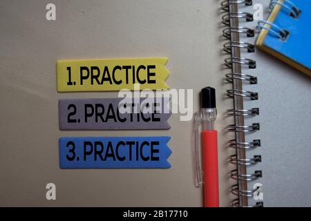 Practice. Practice. Practice text on sticky notes isolated on office desk Stock Photo