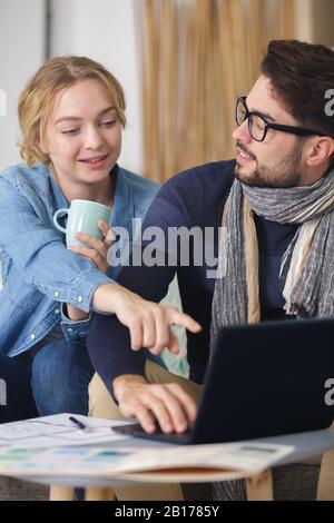 cheerful good looking couple on the sofa Stock Photo