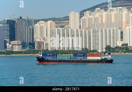 Container boat passes Yau Tong and Cha Kwo Ling in Hong Kong, China Stock Photo