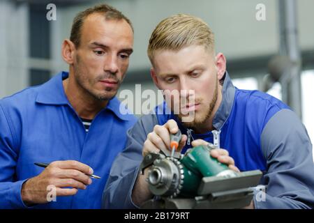 auto mobile and motorcycle mechanic working on piece Stock Photo