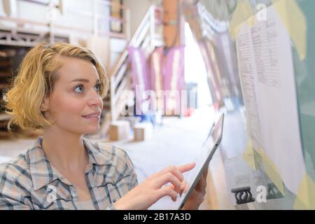 smiling blonde female engineer checking planing Stock Photo