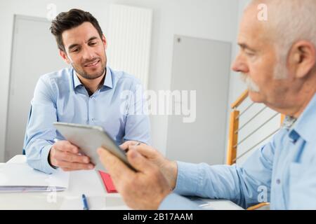 professional adviser showing important information to client Stock Photo
