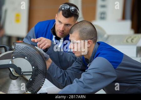 student in carpentry class using circular saw Stock Photo