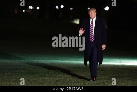 United States President Donald J. Trump waves to the press as he returns to the White House in Washington, DC on February 21, 2020 from Las Vegas where he delivered remarks at a Keep America Great Rally. Credit: Leigh Vogel/Pool via CNP | usage worldwide Stock Photo