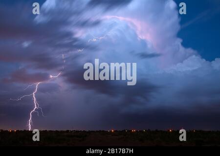 Dramatic cumulonimbus cloud and lightning bolt strike in a severe thunderstorm near Midland, Texas Stock Photo