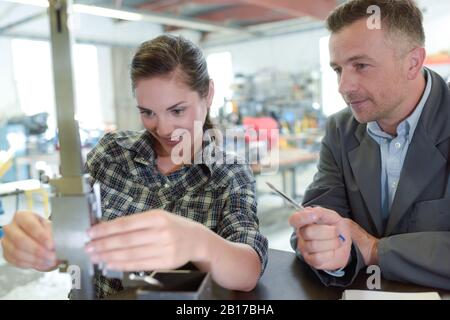 female engineer quality controlling components in factory Stock Photo