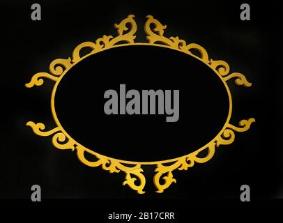 Old vintage gold oval wooden frame isolated on black background Stock Photo