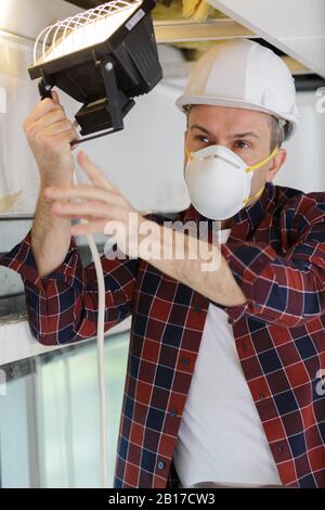 a man is working on home insulation work Stock Photo