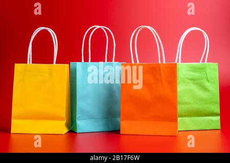 Colorful shopping or gift bags isolated on red Stock Photo