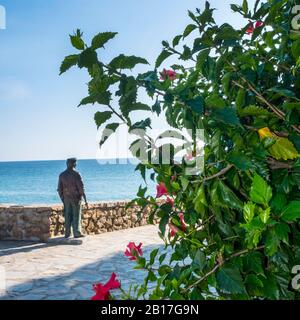 Terrace overlooking the sea in Nerja a charming resort on the Costa del Sol in Southern Spain with a statue of a fisherman looking out to sea Stock Photo